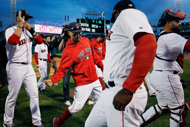 Mookie Betts, center, celebrates with teammates after the Red Sox notched their 108th win of the year, defeating the Yankees in Sunday’s regular-season finale at Fenway Park.