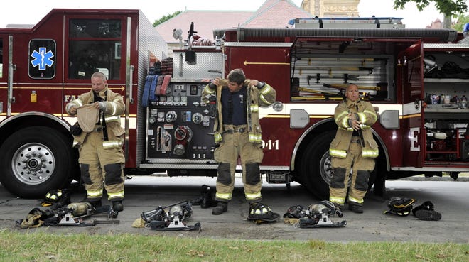 Firefighters Shawn Harrington, Todd Cox and Chris Siwik demonstrate putting on their gear during the Fun Day with the Fairhaven Fire Department held recently at the Millicent Library. [DAVID W. OLIVEIRA/STANDARD-TIMES SPECIAL/SCMG]