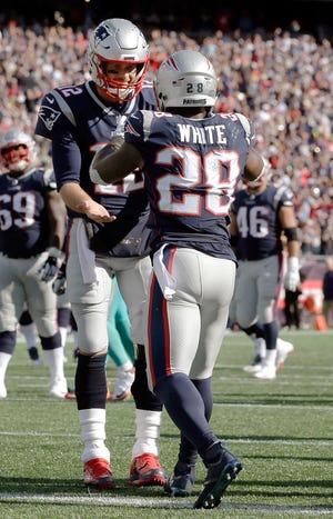 New England Patriots running back James White, right, celebrates his touchdown catch with quarterback Tom Brady during the second half of Sunday's game against the Miami Dolphins in Foxboro. 

(AP Photo/Steven Senne)