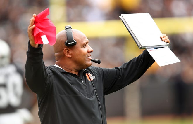 Cleveland Browns head coach Hue Jackson holds up a challenge flag during the second half of an NFL football game against the Oakland Raiders in Oakland, Calif., Sunday, Sept. 30, 2018. (AP Photo/Ben Margot)