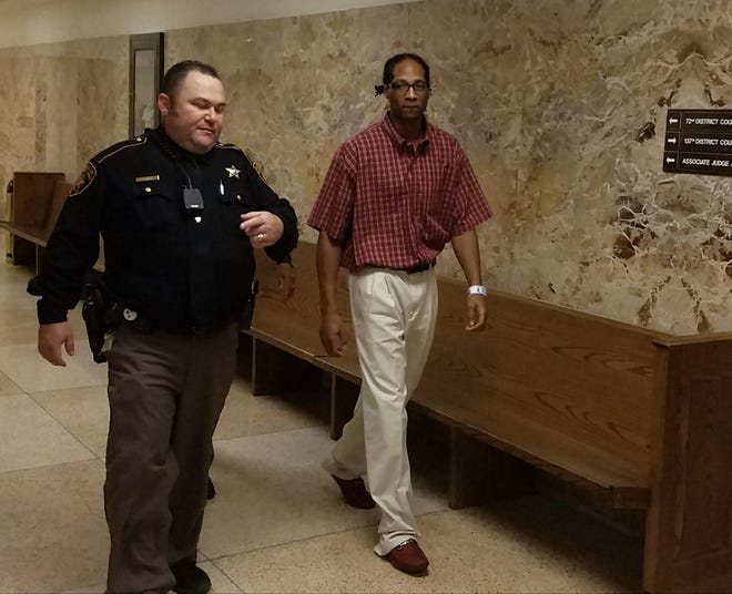 A Lubbock County Sheriff's Deputy escorts Earl Washington after a jury was selected to hear his murder trial in August 2017. [Gabriel Monte/A-J Media]