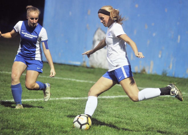 Chippewa's Bailey Clark (right) kicks the ball past Northwestern's Ceili Smith during their WCAL game Monday at Northwstern High. The Chipps stayed perfect in the league with a 3-0 victory over the Huskies.