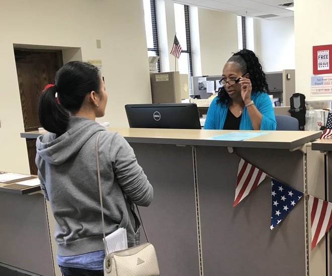 Lien Kieu Miles talks with a Volusia County elections worker about obtaining an early ballot Monday. The elections office will be mailing the first batch of absentee ballots on Tuesday. [Mark Harper/News-Journal]