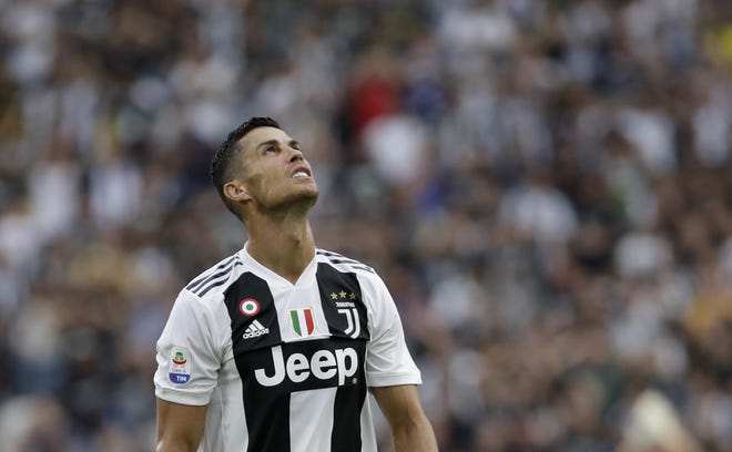 FILE - In this Aug. 25, 2018 file photo Juventus' Cristiano Ronaldo looks to the sky as he reacts during the Serie A soccer match between Juventus and Lazio at the Allianz Stadium in Turin, Italy. Ronaldo is being sued by a Nevada woman who said he raped her in the penthouse suite of a Las Vegas hotel in 2009 and then dispatched a team of þÄúfixersþÄù to obstruct the criminal investigation and trick her into keeping quiet for $375,000. The suit filed Thursday asks the Clark County District Court to void the 2010 settlement and non-disclosure agreement, claiming the woman was so traumatized by the events that she was incapable of participating in negotiations. (AP Photo/Luca Bruno, file)