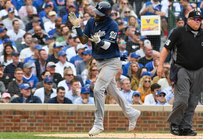 Milwaukee Brewers' Orlando Arcia (3) claps after scoring during the third inning of a tiebreak baseball game against the Chicago Cubs on Monday, Oct. 1, 2018, in Chicago. (AP Photo/Matt Marton)