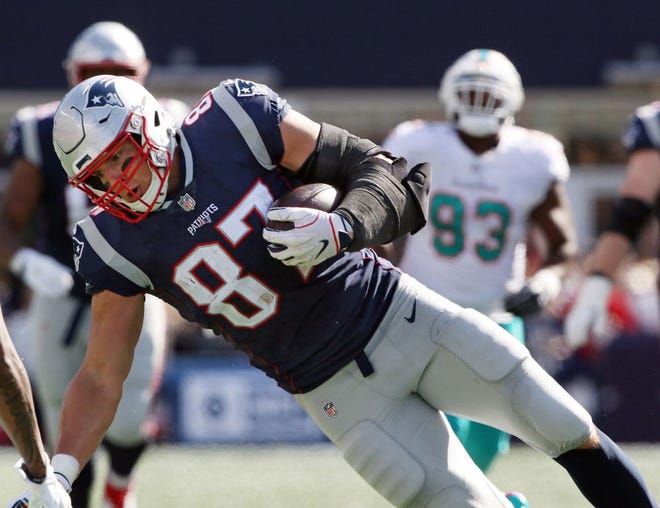 Rob Gronkowski hauls in a pass against the Dolphins on Sunday.