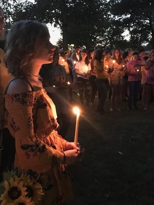 Classmates and friends of Kennedy Freese attend a candlelight vigil Monday at Latham Park. [Photo by Jean Ann Miller/The Courier]