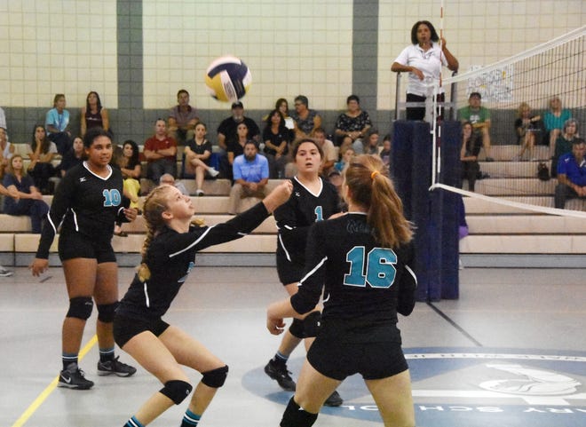 Destin's Kyla Buehner bumps the ball up during the first set against St. Mary's Monday in middle school volleyball action. Destin won the match in two sets. [TINA HARBUCK/THE LOG]