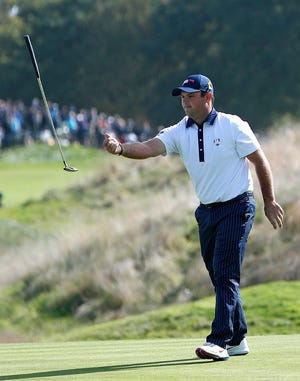 Patrick Reed of the United States tosses his putter into the air after missing a shot during a fourball match on the second day of the Ryder Cup. [Alastair Grant/The Associated Press]