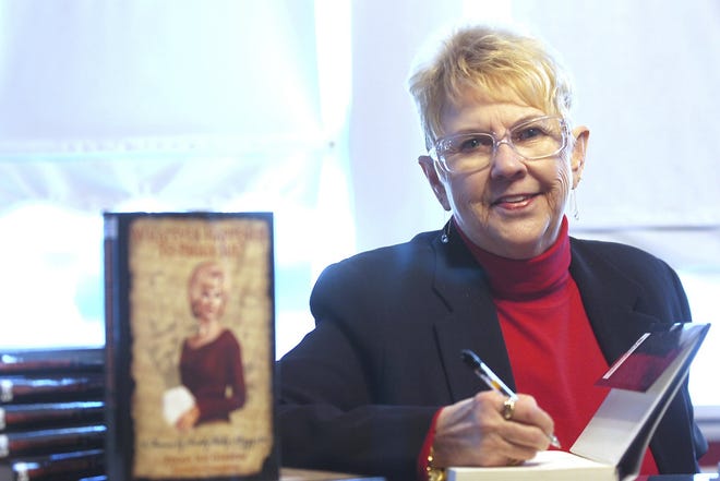 In this Jan. 11, 2008, file photo, Peggy Sue Gerron unveils her new book "What Ever Happened to Peggy Sue" during a press conference in Tyler, Texas. Gerron, the Texas woman who inspired the 1958 Buddy Holly song "Peggy Sue" has died at a Lubbock hospital. Gerron Rackham of Lubbock died Monday, Oct. 1, 2018, at University Medical Center. She was 78. (Jaime R. Carrero/Tyler Morning Telegraph, via AP, File)