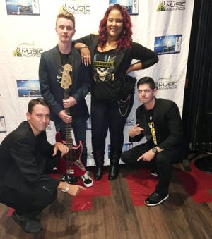 A trio of local musicans joined an award-winner on stage recently during the New England Music Awards. They accompanied Jazzmyn RED who won Hip Hop Act of the Year. Pictured from left are: Max Wolski of Mattapoisett (keyboard), Patrick Igoe of Mattapoisett (bass), Jazzmyd RED of Randolph (vocals) and Andrew Madeira of New Bedford (percussion).  [Submitted photo]