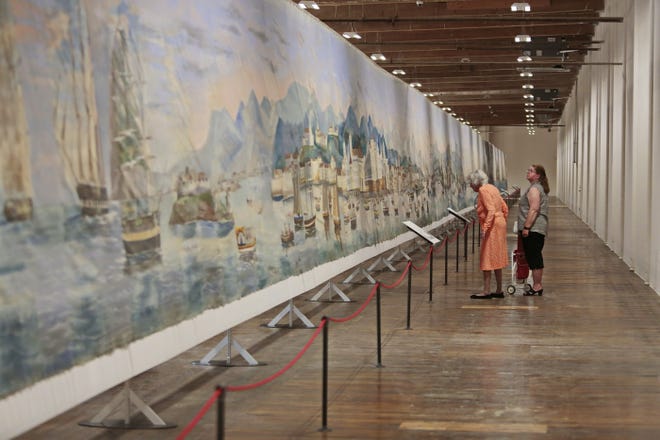 Guets take in the scenes as the Whaling Museum's 1848 Grand Panorama of a Whaling Voyage 'Round the World, at Kilburn Mill in the South End of New Bedford. [PETER PEREIRA/THE STANDARD-TIMES/SCMG]