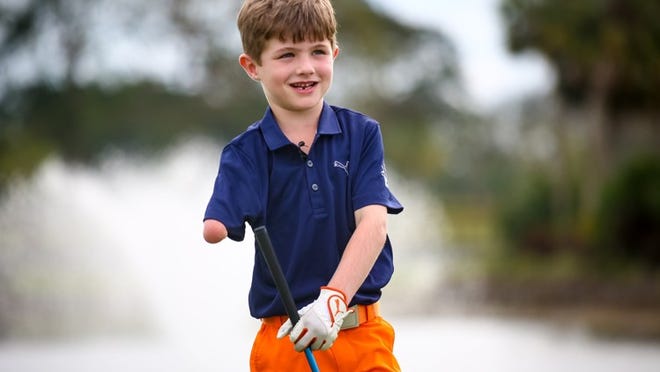 Tommy Morrissey, a one-armed golfer from Palm Beach Gardens, smiles at players during his One Arm Challenge at the Honda Classic in Palm Beach Gardens on Feb. 21, 2017, when he was just six years old. (Richard Graulich / The Palm Beach Post)