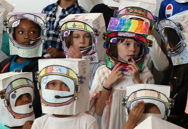 Pell Elementary School became the first public school in Rhode Island to have a conversation with an astronaut aboard the International Space Station. Students wear paper astronaut helmets that they made for the space chat. [The Providence Journal / Bob Breidenbach]