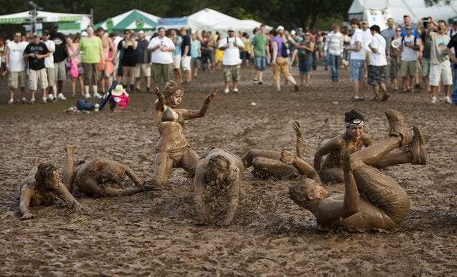 Music fans play in the mud at the Austin City Limits Music Festival after heavy rains turned Zilker Park into a giant mud pit on Oct. 4, 2009. This year, a small but notable chance of rain is in the forecast for the first weekend of the festival. [JAY JANNER/AMERICAN-STATESMAN 2009]