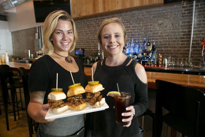 Server Rachel Reische and Bartender Taeylor LaForest serve up some pork sliders and sweet tea at Two09 West Main in downtown Leesburg. [Cindy Sharp/Correspondent]
