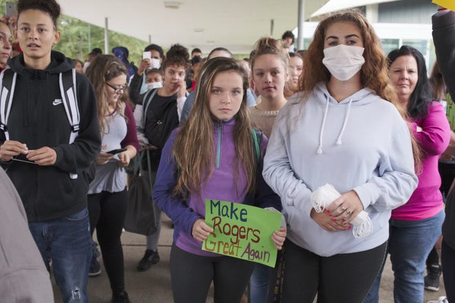 Rogers High School students staged a walkout Wednesday protesting the conditions at the school. Many carried signs and wore masks to highlight the need for a better learning environment. [PETER SILVIA PHOTO]