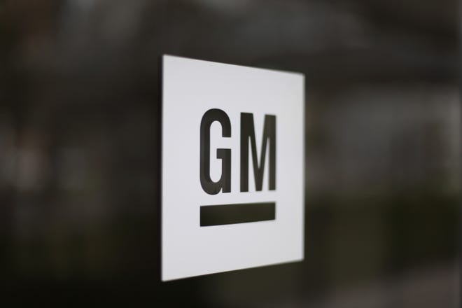 FILE - This Friday, May 16, 2014, file photo, shows the General Motors logo at the company's world headquarters in Detroit. General Motors and Honda are teaming up to create a self-driving vehicle. (AP Photo/Paul Sancya, File)