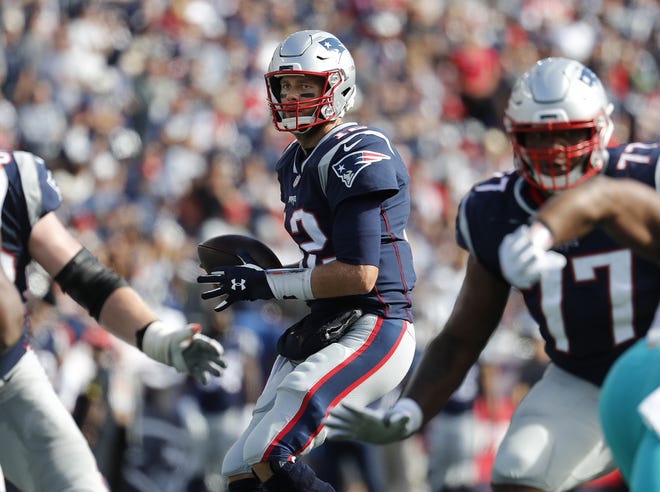 New England Patriots quarterback Tom Brady drops back to pass during a NFL game against the Miami Dolphins at Gillette Stadium Sunday. [WINSLOW TOWNSON/AP IMAGES FOR PANINI]