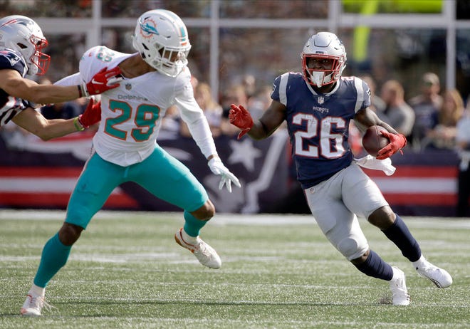 Patriots running back Sony Michel, right, cuts back to avoid the Dolphins' Minkah Fitzpatrick last Sunday in Foxboro. Michel finished the game with 112 yards on the ground and a touchdown.