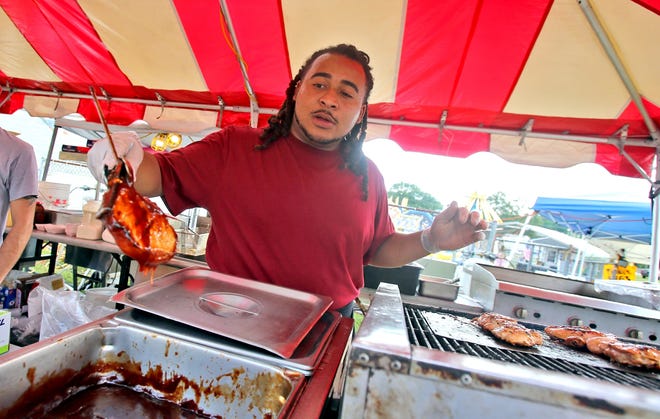Tony Torres cooks up pork chops at the Fryday food booth at the Cleveland County Fair on Friday. [Brittany Randolph/The Star]