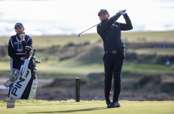 England's Tyrell Hatton, the defending champion, tees off at the 15th hole Thursday on day one of the Dunhill Links Championship at St Andrews, Scotland. [Kenny Smith/PA via AP]