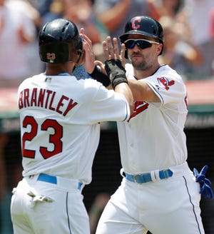 The Indians’ Lonnie Chisenhall, right, and Michael Brantley, celebrating after both scored in a June game, likely are reaching the end of the road in Cleveland. Chisenhall isn't on the Indians' roster in the postseason.