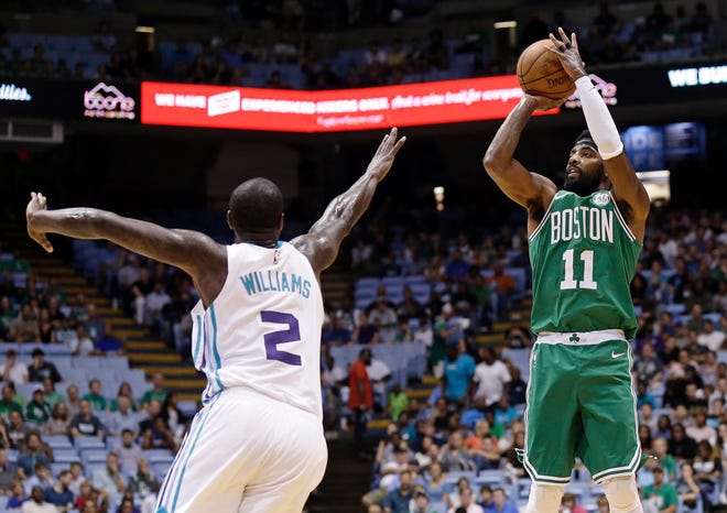 Kyrie Irving shoots over Charlotte's Marvin Williams in Chapel Hill, N.C., on Sept. 28.