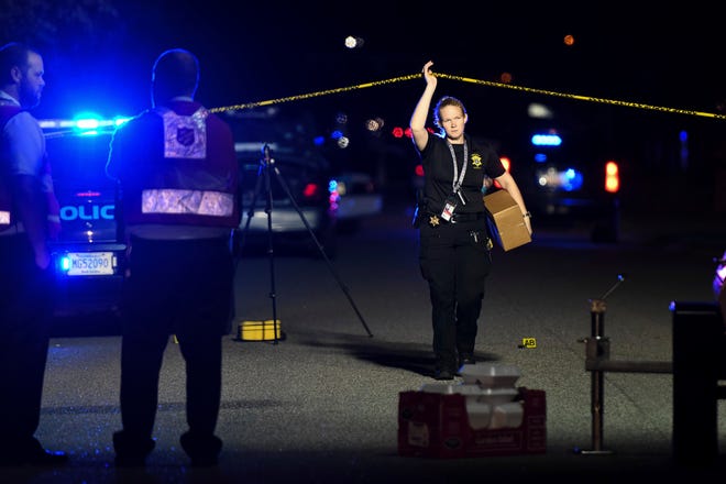 A member of the sheriff's department exits the crime scene on Ashton Drive in the Vintage Place neighborhood where several members of law enforcement were shot, one fatally, Wednesday, Oct. 3, 2018, in Florence, S.C. (AP Photo/Sean Rayford)