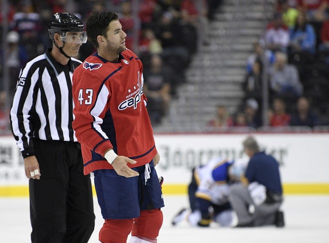 Washington Capitals right wing Tom Wilson is escorted by an official off the ice after he checked St. Louis Blues center Oskar Sundqvist, on ice at back center, during the second period of an NHL preseason hockey game on Sept. 30. Wilson has been suspended 20 games by the NHL for a blindside hit to the head of an opponent during a preseason game. [AP Photo/Nick Wass, File]