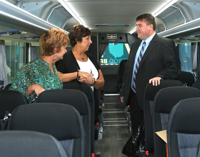 Jeremiah Johnson, Democratic candidate for the Ohio House 98th District, talks with visitors on the Democratic People First bus Wednesday in New Philadelphia. (TimesReporter.com / Jim Cummings)