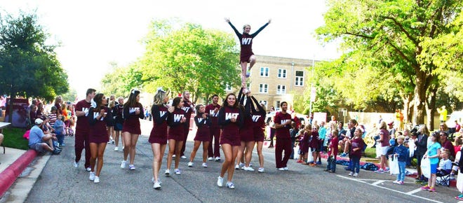 Cheerleaders get the crowd in high spirits at a previous WTAMU homecoming parade. [Provided Photo]