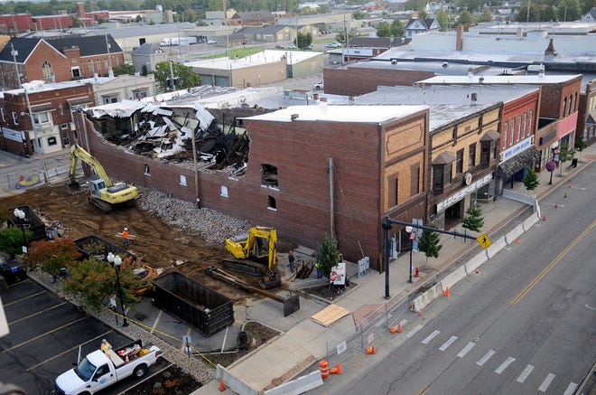 The demolition of the former Weiss Pharmacy building continues on Friday. Page Excavating is handling the demolition.