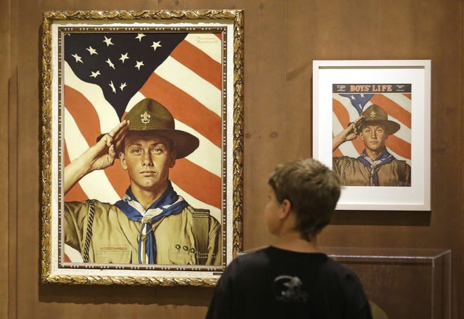 FILE - In this July 22, 2013, file photo, Andrew Garrison, 11, of Salt Lake City, looks over the Rockwell exhibition at the Mormon Church History Museum in Salt Lake City, Utah. The Mormon church's new youth program it will roll out in 2020 when it cuts all ties with Boy Scouts of America will still include outdoor and adventure activities even as the initiative becomes more gospel-focused, the faith confirmed Friday, Sept. 21, 2018. [AP Photo/Rick Bowmer, File]