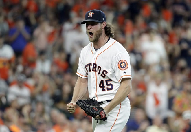 Houston Astros starting pitcher Gerrit Cole (45) reacts after striking out Cleveland Indians' Jose Ramirez to end the sixth inning of Game 2 in an American League Division Series on Saturday in Houston. [AP Photo/David J. Phillip]