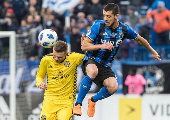 Montreal Impact's Alejandro Silva, right, challenges Columbus Crew SC's Wil Trapp during second half MLS soccer action in Montreal, Saturday, Oct. 6, 2018. (Graham Hughes/The Canadian Press via AP)
