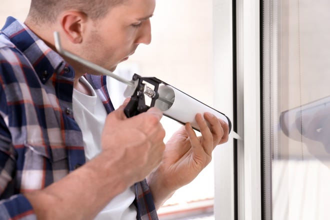 Sealing up windows with caulk is an easy and effective way to prevent drafts. (Dreamstime)
