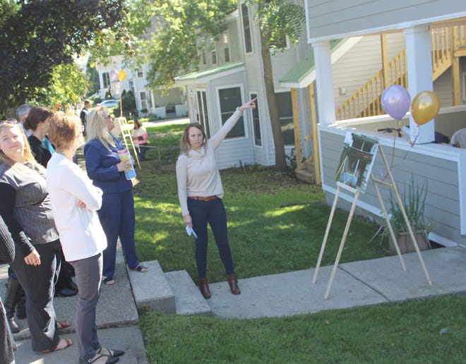 Jessica Wilcox shows a crowd some of the improvements made at a West First Street property thanks in part to the financial help of the Corning Housing Partnership. [Jana Aiken/The Leader]