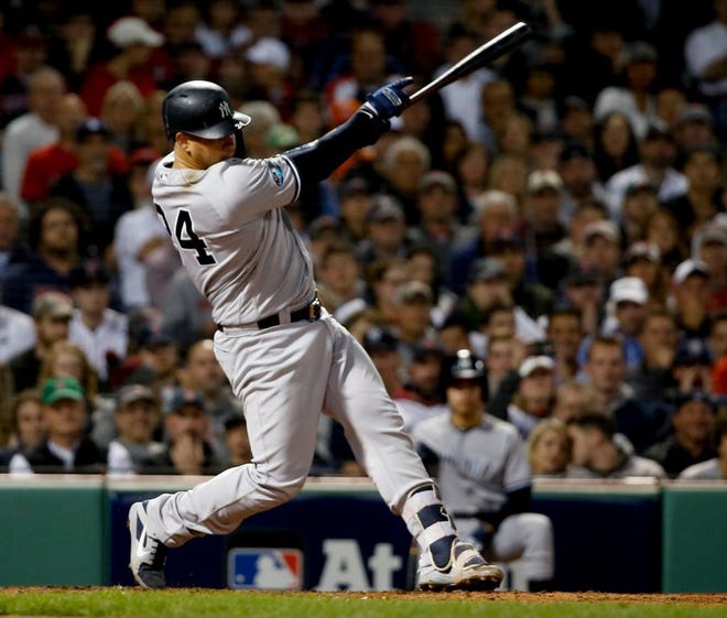The Yankees' Gary Sanchez follows through with his swing on a three-run home run against the Red Sox in the seventh inning of Game 2 of the American League Division Series on Saturday night. The blast gave New York a 6-1 lead.
