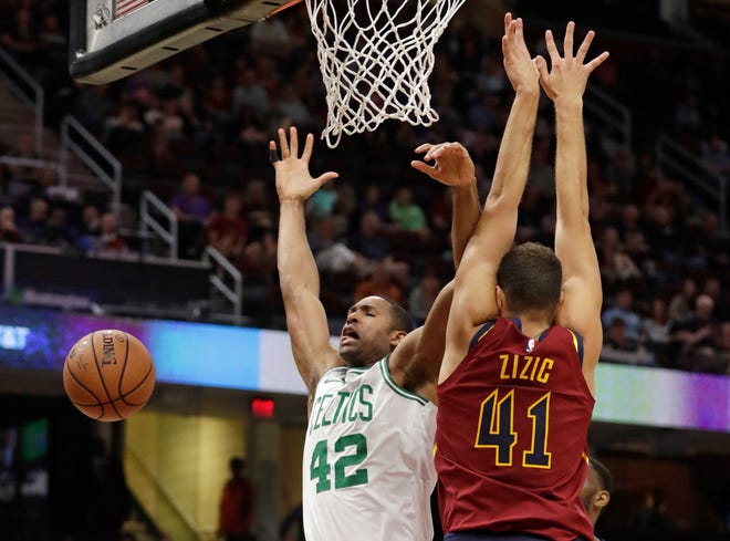 The Celtics' Al Horford loses control of the ball against the Cavaliers' Ante Zizic during the first half of Saturday's preseason game.