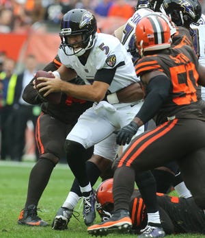 Baltimore Ravens quarterback Joe Flacco is sacked by Cleveland Browns' Myles Garrett Sunday at FirstEnergy Stadium in Cleveland.