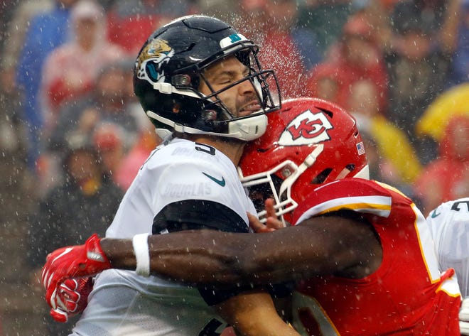 Jacksonville's Blake Bortles, left, is hit by Kansas City's Justin Houston after throwing a pass during the first half Sunday in Kansas City, Missouri. [Associated Press/Charlie Riedel]