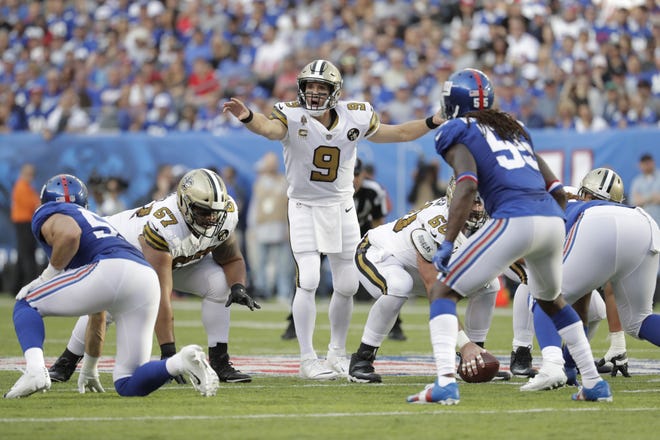 New Orleans Saints quarterback Drew Brees runs a play during the first half of a game against the New York Giants on Sept. 30. [AP Photo/Julio Cortez]