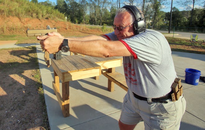 Bob Watson sets up to shoot on range five at the Foothills Public Shooting Complex on Thursday. Range five, usually used for skeet and trap, currently serves multiple shooting styles while additional bays are added to the 50-yard riffle and pistol range. [Brittany Randolph/The Star]