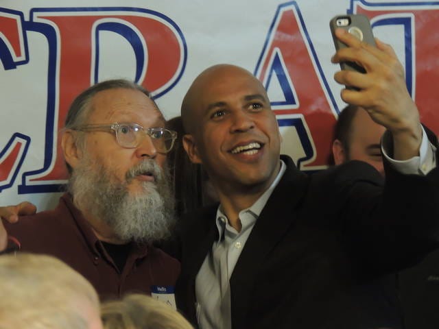 U.S. Sen. Cory Booker, D-N.J., takes a selfie with a supporter following an event Monday at the Boone County Democrats headquarters. Photo by Michael Crumb/Ames Tribune