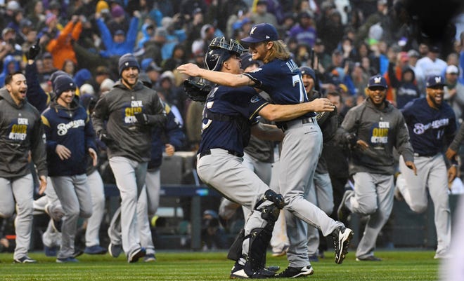 Brewers relief pitcher Josh Hader celebrates with catcher Erik Kratz after getting the Rockies' Ian Desmond for the final out in Game 3 on the NLDS on Sunday. Kratz was drafted in 2002 by the Blue Jays. [John Leyba/Associated Press]