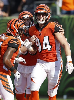 Bengals defensive end Sam Hubbard (94) celebrates his fourth-quarter touchdown on a fumble return, the capper on Cincinnati's comeback win over the Dolphins in Paul Brown Stadium. [Frank Victores/The Associated Press]