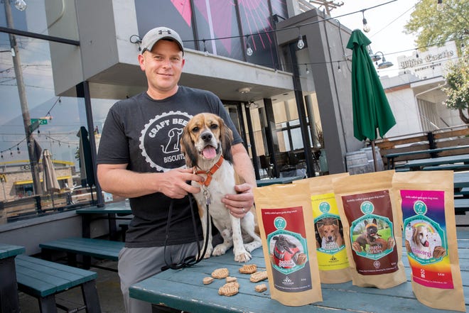 Brian Ratliff and his dog, Brewster, on the patio of Endeavor Brewing Co.