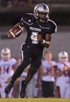 Ledford's Robin Martin runs after his third interception of the four he had in the game against Central Davidson on Friday. [Donnie Roberts/The Dispatch]