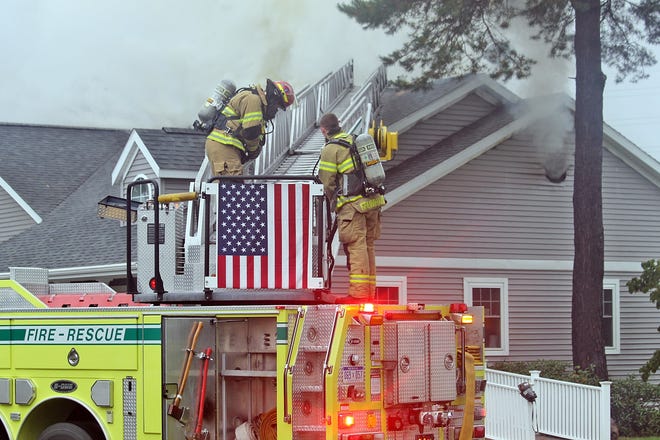 Hillsdale City firefighters prepare to ventilate the roof Saturday morning. [COREY MURRAY PHOTO]